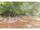 Outdoor area with built-in stone picnic tables and BBQ grills surrounded by mature trees for entertaining and relaxation at 2965 Pharr Court South Nw # 518, Atlanta, GA 30305
