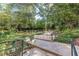 Beautiful backyard featuring a tranquil garden with stone steps and wrought-iron railings, surrounded by lush greenery at 2965 Pharr Court South Nw # 518, Atlanta, GA 30305