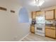 A kitchen area featuring light wood cabinets and wood style flooring at 2965 Pharr Court South Nw # 518, Atlanta, GA 30305