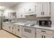 Well-maintained kitchen with white cabinets, appliances, and ample counter space at 2965 Pharr Court South Nw # 518, Atlanta, GA 30305
