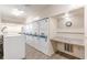 Laundry room with multiple stacked washer and dryer units and ample counter space at 2965 Pharr Court South Nw # 518, Atlanta, GA 30305