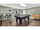 Spacious basement features a pool table, bar stools, and an inviting yellow arm chair at 269 Hidden Wood Ct, Lawrenceville, GA 30043