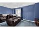 Basement rec room area featuring comfortable seating, a window, and neutral carpeting for a cozy atmosphere at 269 Hidden Wood Ct, Lawrenceville, GA 30043