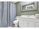 The bathroom features a white vanity, toilet, and a shower with a silver pattern curtain at 269 Hidden Wood Ct, Lawrenceville, GA 30043