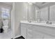 Bathroom with a double sink vanity, bright lighting, and a separate toilet room at 269 Hidden Wood Ct, Lawrenceville, GA 30043