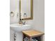 Bathroom with white sink, gold mirror, faucet, and towel ring with a storage bin at 269 Hidden Wood Ct, Lawrenceville, GA 30043