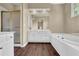 Bathroom featuring a large soaking tub, white cabinets, and a glass enclosed shower for modern convenience at 269 Hidden Wood Ct, Lawrenceville, GA 30043