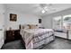 Bedroom featuring a queen bed, ceiling fan, neutral paint and plush carpet at 269 Hidden Wood Ct, Lawrenceville, GA 30043