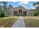 Beautiful clubhouse with a manicured lawn, stone accents, a covered entrance, and well-placed shrubbery at 269 Hidden Wood Ct, Lawrenceville, GA 30043