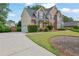 Two-story brick home with a three-car garage, mature landscaping, and an inviting driveway at 269 Hidden Wood Ct, Lawrenceville, GA 30043