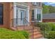 Home's front door has glass pane; brick stairs lead up to the entrance with black railings at 269 Hidden Wood Ct, Lawrenceville, GA 30043
