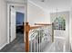 Bright hallway featuring hardwood railing, neutral walls, and a view of the front door and an adjacent room at 269 Hidden Wood Ct, Lawrenceville, GA 30043