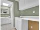 Charming laundry room features bright white cabinets and adjacent vanity with ample storage at 269 Hidden Wood Ct, Lawrenceville, GA 30043