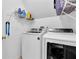 Convenient laundry room with a washer, dryer, and shelving for storage at 269 Hidden Wood Ct, Lawrenceville, GA 30043