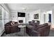 Spacious living room with a fireplace, built-in shelving, and lots of natural light at 269 Hidden Wood Ct, Lawrenceville, GA 30043
