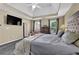 Spacious main bedroom featuring a tray ceiling, comfortable bedding, with two windows for natural light at 269 Hidden Wood Ct, Lawrenceville, GA 30043