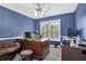 Home office featuring blue walls, a ceiling fan, a large desk and two computer monitors for working from home at 269 Hidden Wood Ct, Lawrenceville, GA 30043