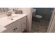 Compact bathroom with grey tiles, pedestal sink, and playful decor creates a functional and stylish space at 3668 Kingsboro Ne Rd # 6, Atlanta, GA 30319