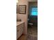 Efficient bathroom with vintage blue tiles, playful decor, and functional fixtures offers a unique and practical space at 3668 Kingsboro Ne Rd # 6, Atlanta, GA 30319
