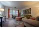 Inviting living room featuring neutral walls, patterned armchairs, a cozy ottoman, and warm lighting at 3668 Kingsboro Ne Rd # 6, Atlanta, GA 30319