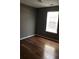 Bedroom featuring hardwood floors, neutral paint, and a window at 4528 Baker Grove Nw Rd, Acworth, GA 30101