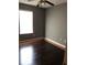 This bedroom features hardwood floors, a ceiling fan, and natural light from a window at 4528 Baker Grove Nw Rd, Acworth, GA 30101