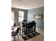 Eat-in kitchen boasts a table with four chairs, a window, and a black and white checkered floor at 4528 Baker Grove Nw Rd, Acworth, GA 30101