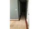 Hallway with hardwood floors on the side, and off-white tile on the interior of the hall at 4528 Baker Grove Nw Rd, Acworth, GA 30101