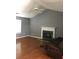 Living room featuring a fireplace, high ceilings, hardwood floors, and a ceiling fan with light at 4528 Baker Grove Nw Rd, Acworth, GA 30101