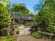 Lush backyard stone patio with outdoor seating surrounded by landscaping and foliage at 1050 E Club Ne Ln, Atlanta, GA 30319