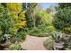 Lush backyard showcasing winding gravel paths, vibrant greenery, and a variety of plant life at 1050 E Club Ne Ln, Atlanta, GA 30319