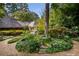 Lush landscaped garden with a small pond, winding stone path, and mature trees at 1050 E Club Ne Ln, Atlanta, GA 30319