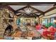 Living room features stone fireplace, beamed ceilings, hardwood floors and ornate area rug at 1050 E Club Ne Ln, Atlanta, GA 30319