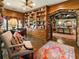 Office featuring custom built-in bookshelf, stone archway, and view to living room at 1050 E Club Ne Ln, Atlanta, GA 30319