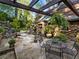 Picturesque stone patio featuring lush landscaping, outdoor furniture, and a charming pergola at 1050 E Club Ne Ln, Atlanta, GA 30319