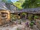 Unique backyard patio area with beautiful plants and seating for outdoor relaxation at 1050 E Club Ne Ln, Atlanta, GA 30319