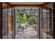 Outdoor living space with a stone patio, dining furniture, and manicured landscaping at 1050 E Club Ne Ln, Atlanta, GA 30319