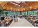 Bright sun room with wood ceiling, ceiling fan, stone accents and walls of windows with wooded views at 1050 E Club Ne Ln, Atlanta, GA 30319