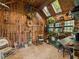 Charming sunroom featuring natural wood paneling, brick floors, and an array of plants and garden tools at 1050 E Club Ne Ln, Atlanta, GA 30319