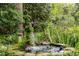 Charming backyard with stone-lined water feature and a unique vine-covered fountain at 1050 E Club Ne Ln, Atlanta, GA 30319
