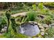 Scenic backyard with a serene pond feature, lush greenery, and artistic accents at 1050 E Club Ne Ln, Atlanta, GA 30319