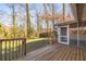Wooden backyard deck with access to the screened porch and green backyard at 2299 Brenda Se Dr, Smyrna, GA 30080