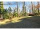 Spacious and well-maintained green backyard bordered by mature trees at 2299 Brenda Se Dr, Smyrna, GA 30080