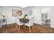 Dining room showcases a rustic table, modern art and doorway views into other living spaces at 2299 Brenda Se Dr, Smyrna, GA 30080