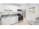 Bright kitchen featuring white cabinets, stainless steel appliances and granite countertops at 2299 Brenda Se Dr, Smyrna, GA 30080