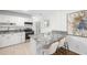 Modern kitchen featuring granite counters, white cabinetry, and breakfast bar seating at 2299 Brenda Se Dr, Smyrna, GA 30080