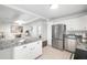 Open kitchen featuring stainless steel appliances, modern white cabinets and granite countertops at 2299 Brenda Se Dr, Smyrna, GA 30080