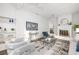 Spacious living room featuring a painted fireplace, built-in shelving, and sleek furniture at 2299 Brenda Se Dr, Smyrna, GA 30080