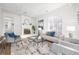 Cozy living room boasts a whitewashed fireplace, modern decor, and abundant natural light at 2299 Brenda Se Dr, Smyrna, GA 30080