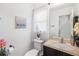 Charming half-bath with a decorative mirror and a lovely sink and vanity at 3281 Old Salem Rd, Conyers, GA 30013